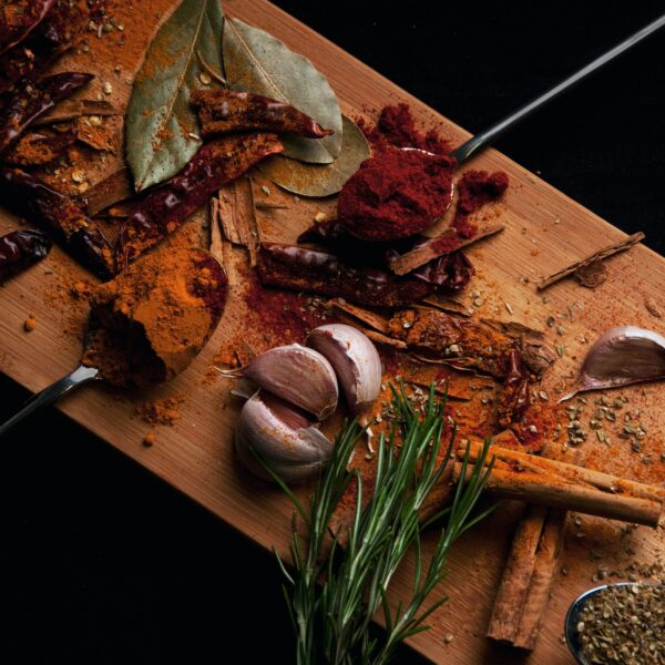 Chopping board with herbs and spices on it