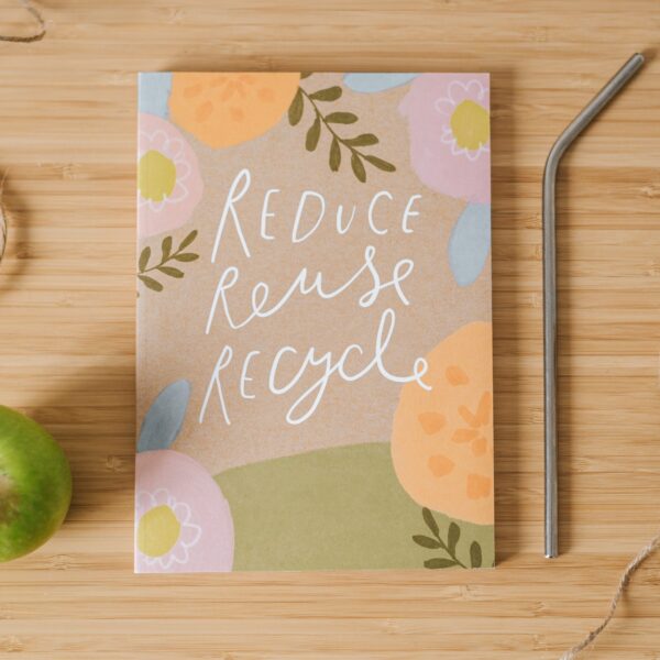 Floral notebook with the words "reduce, reuse, recycle" written on the cover